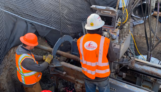 2 workers wearing orange hi vis vests