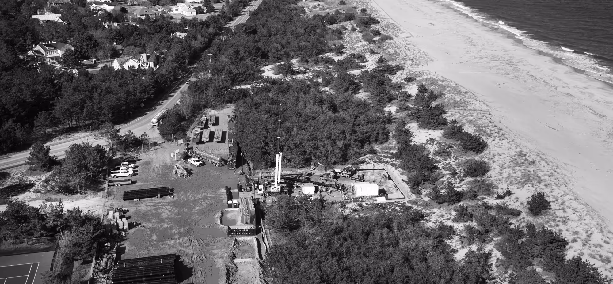 an aerial photo of a beach with a construction pit