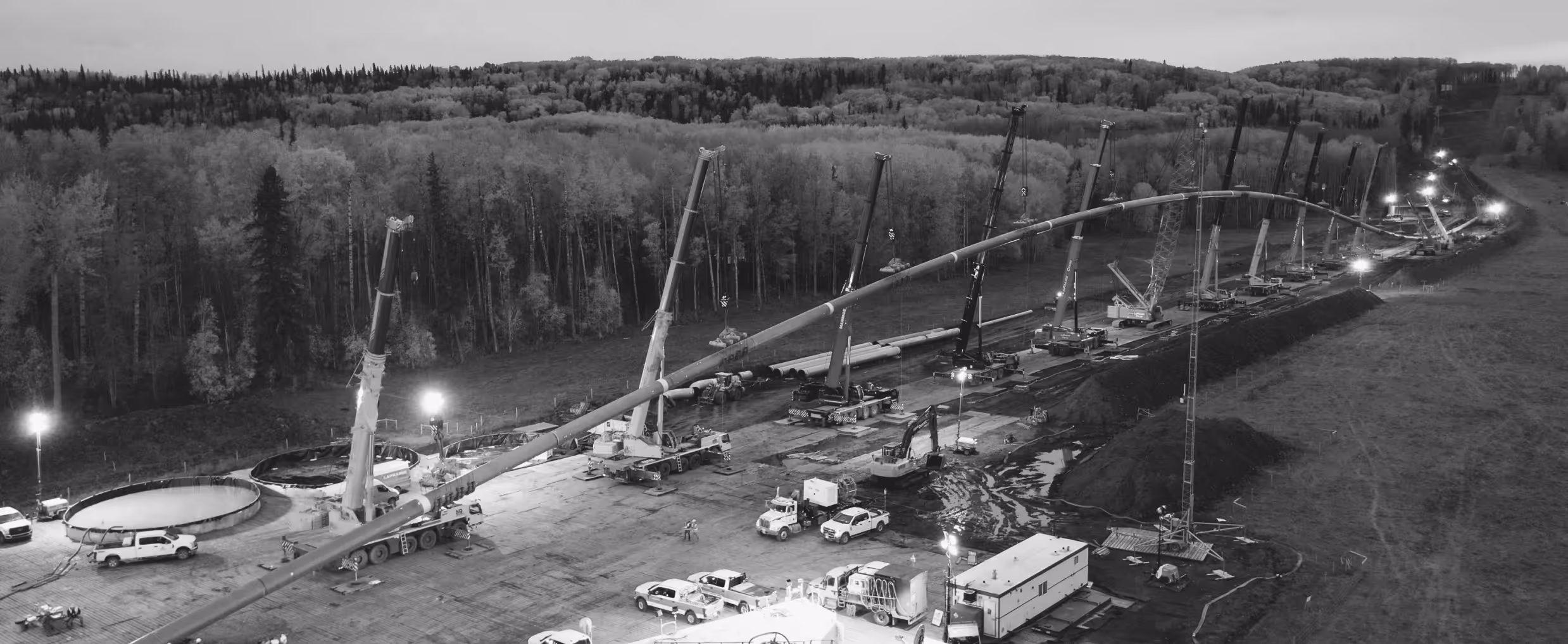 an hdd installation pipeline being pulled by cranes
