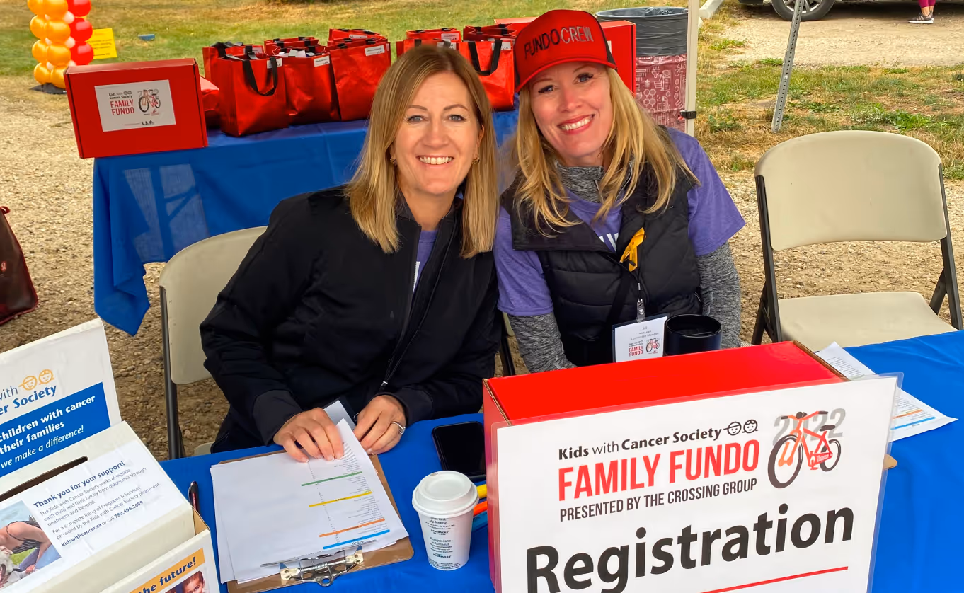 2 ladies working at the family fundo registration table