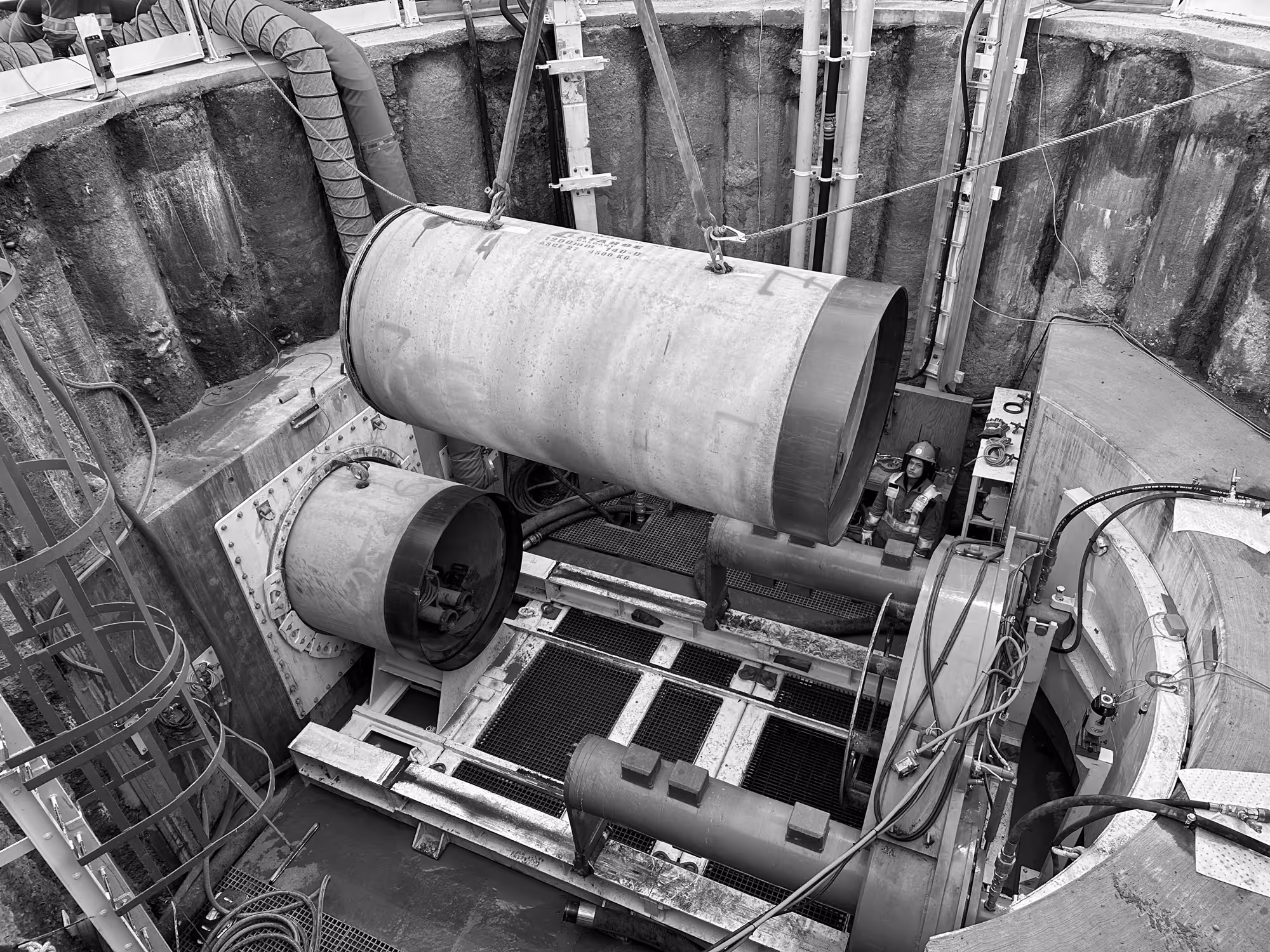 a microtunneling machine being lowered into a pit