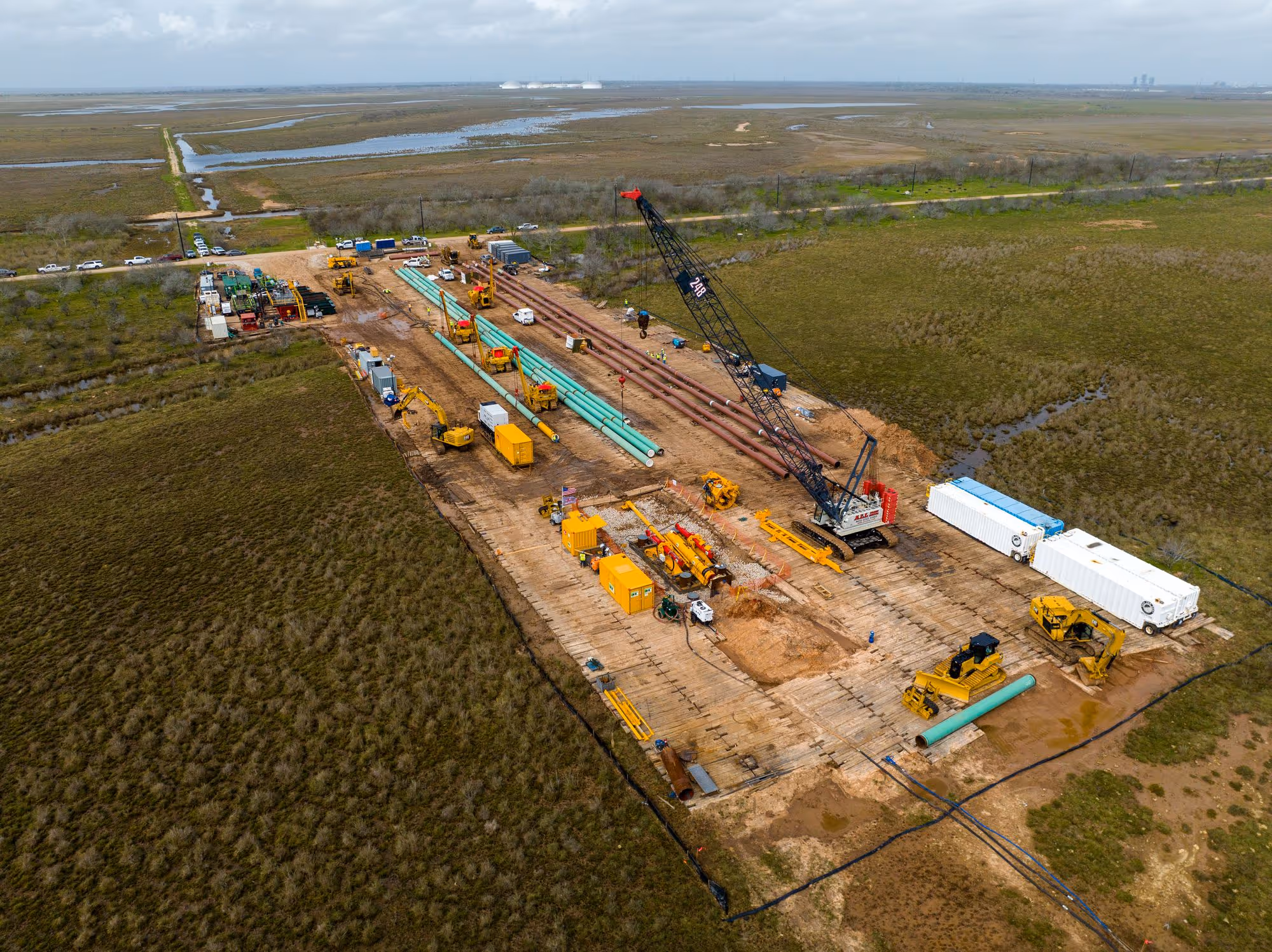 an aerial shot of a work site near a river