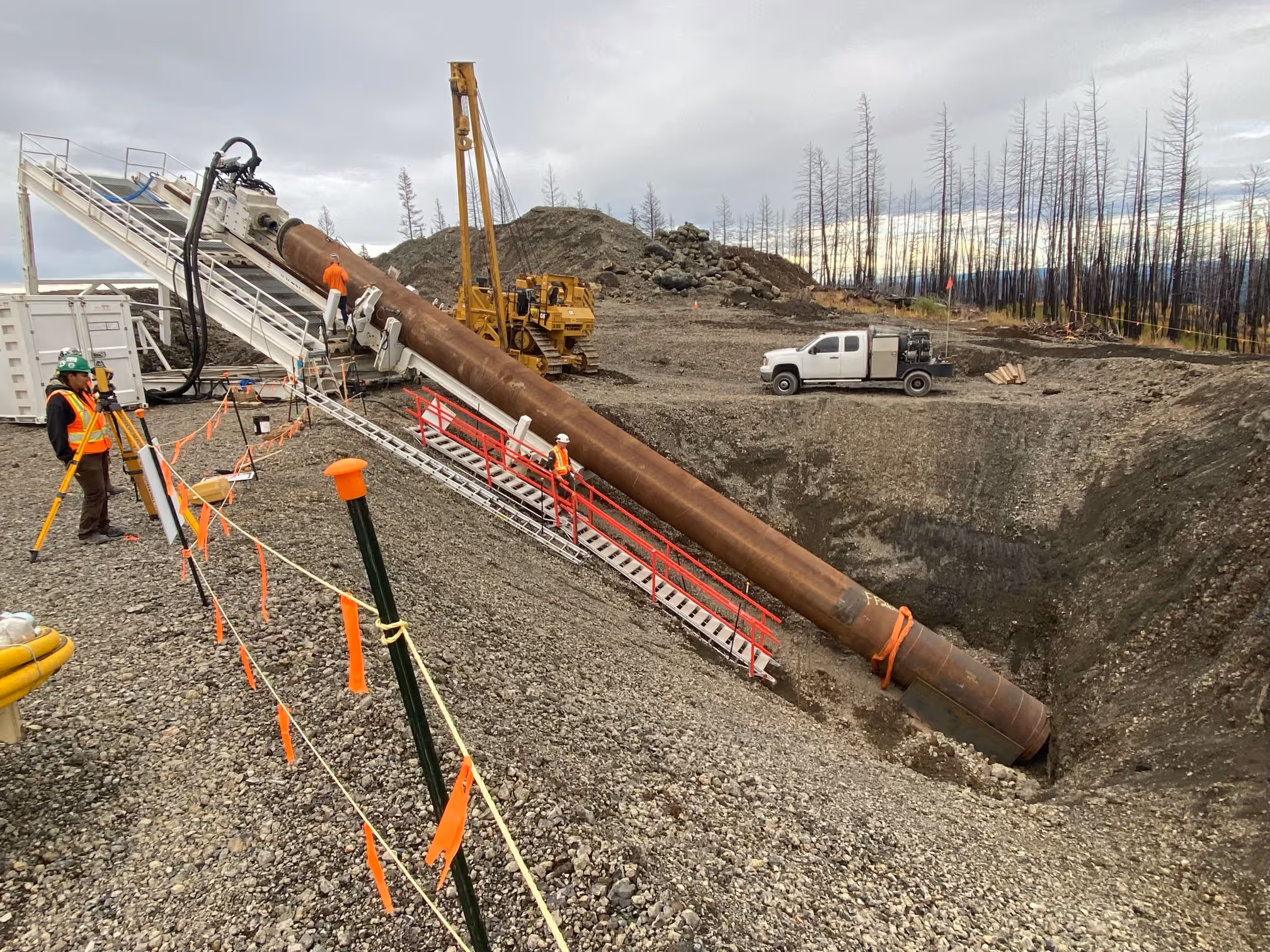 a pipeline going into the ground at an extreme angle