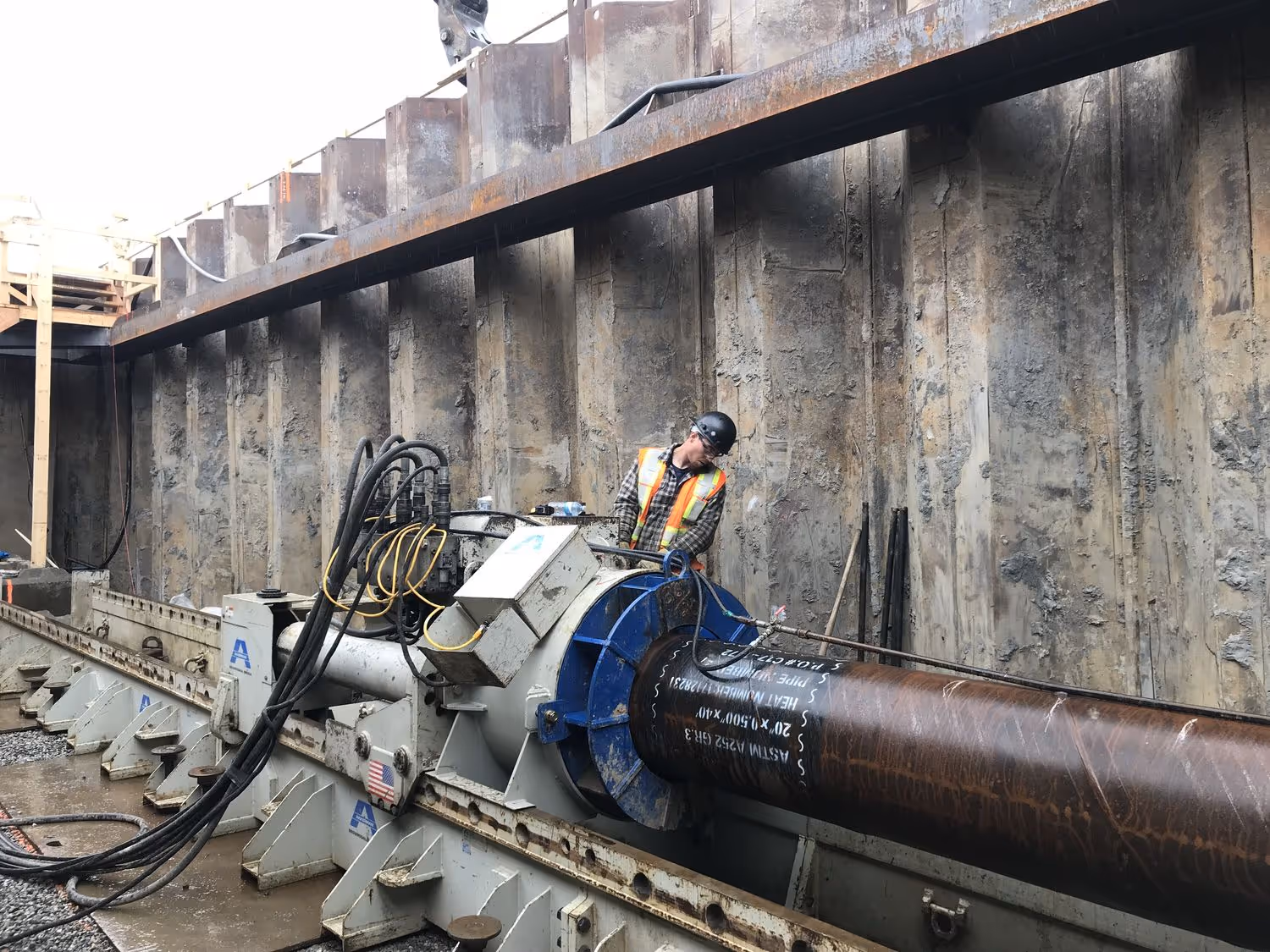 a worker looks at the pipe