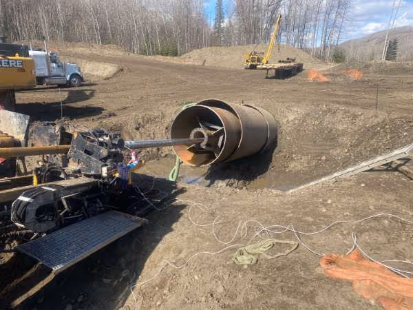 a pipe being pushed into larger pipes - casing