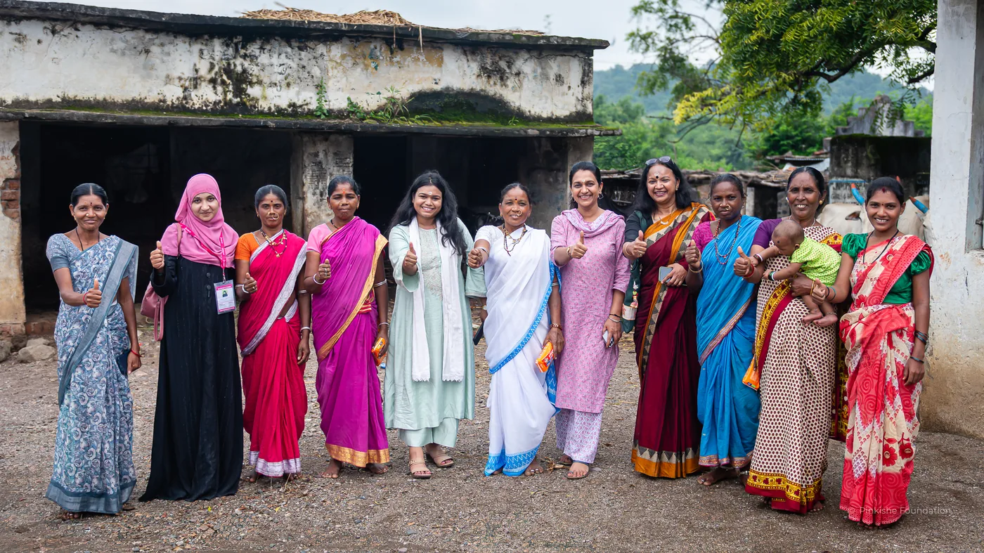 Women standing together at a Pinkishe community programme in Telangana