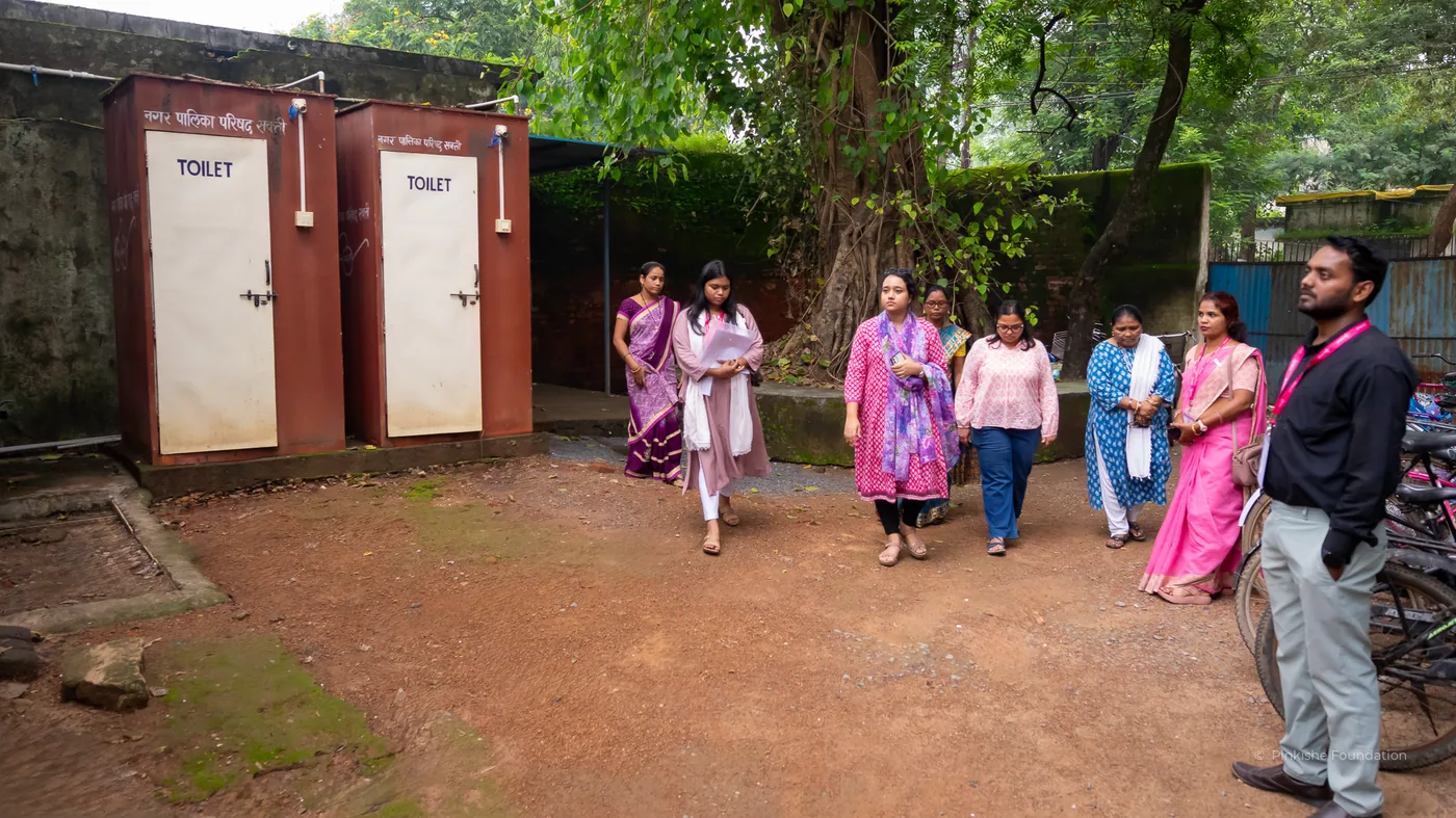 Women walking towards a school toilet block in Chhattisgarh