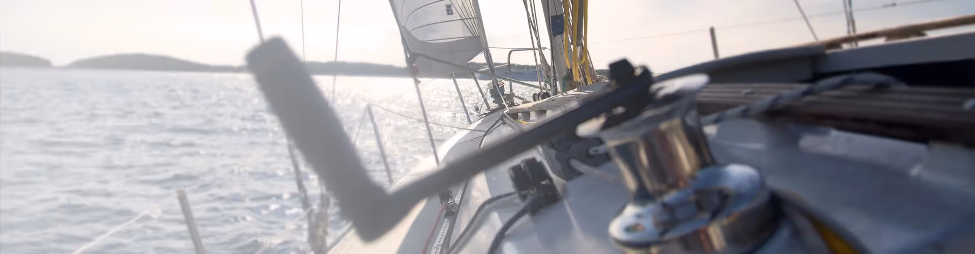 A sailing yacht heading across a sparlking ocean