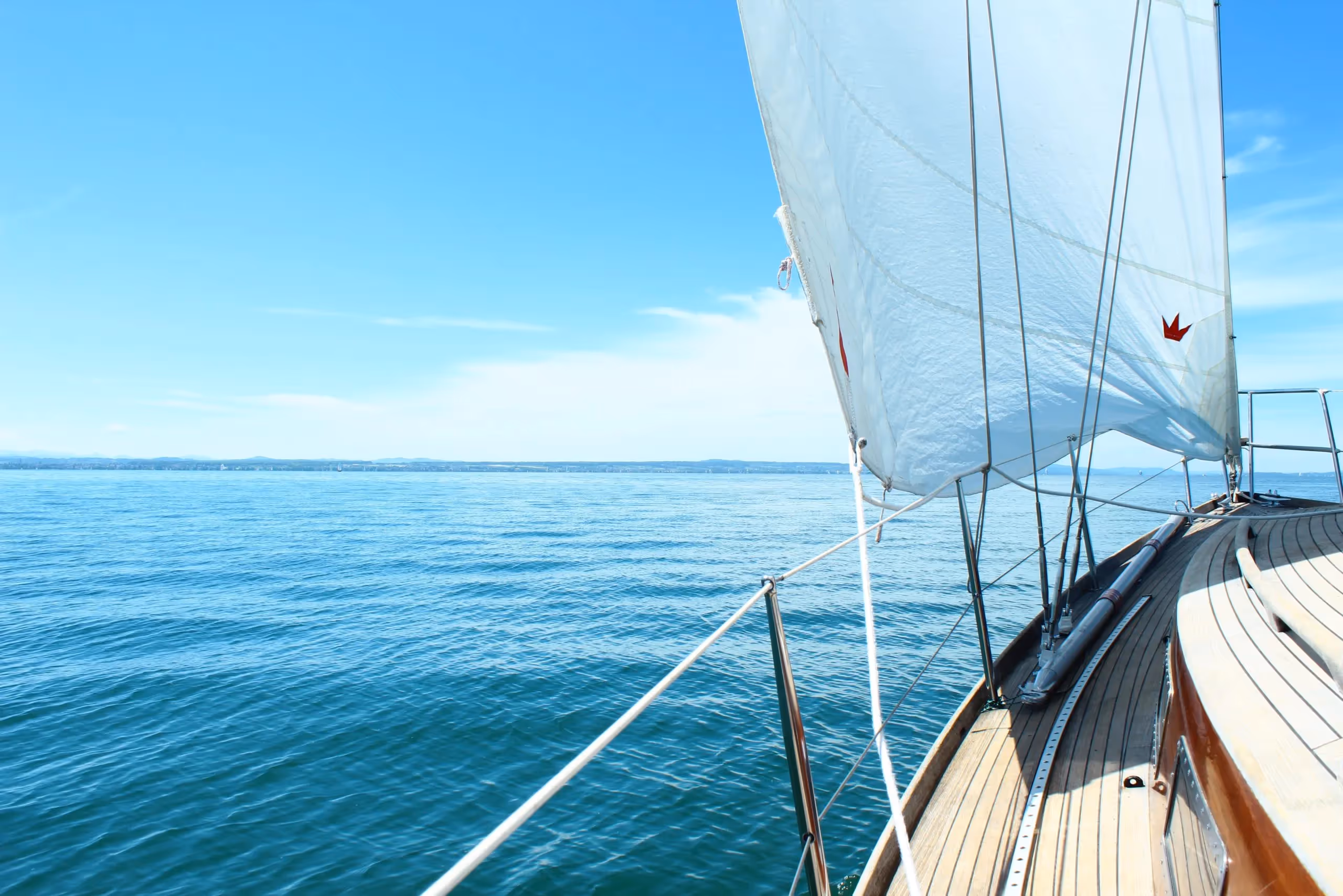 A wooden yacht sailing the ocean
