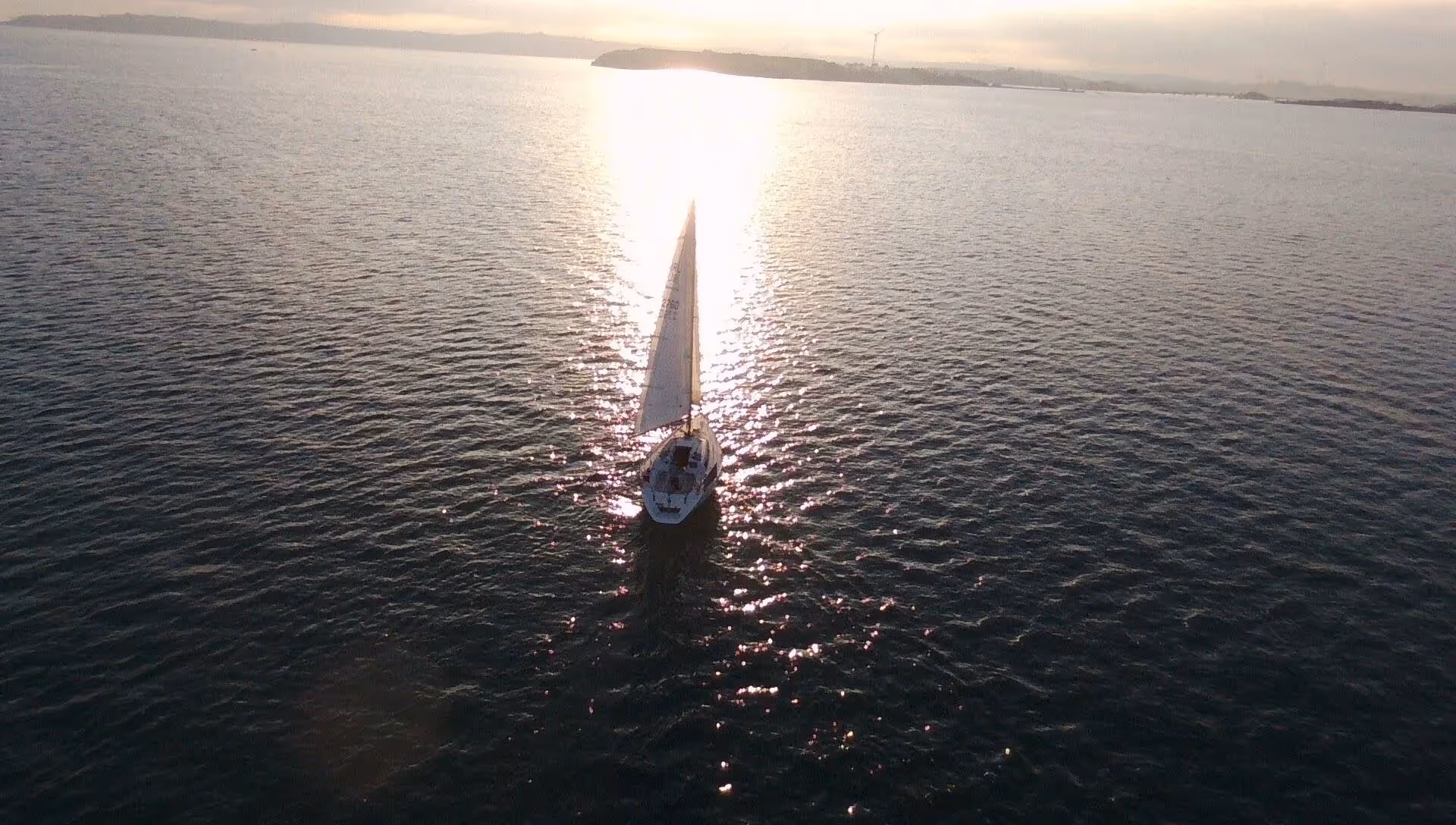 A yacht sailing a sunny ocean