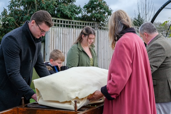a group of people standing around a wooden box
