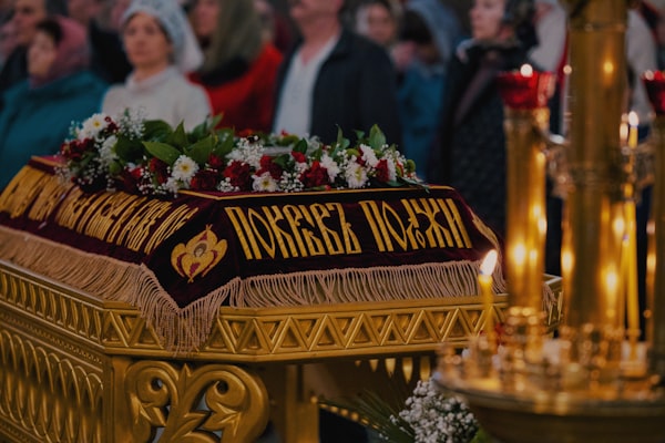 A decorated coffin is the focus of the ceremony.