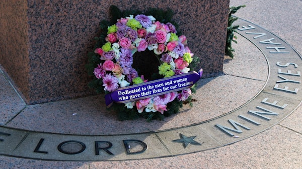 a wreath of flowers is placed in front of the national war memorial