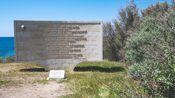 A memorial sits on the edge of a cliff overlooking the ocean