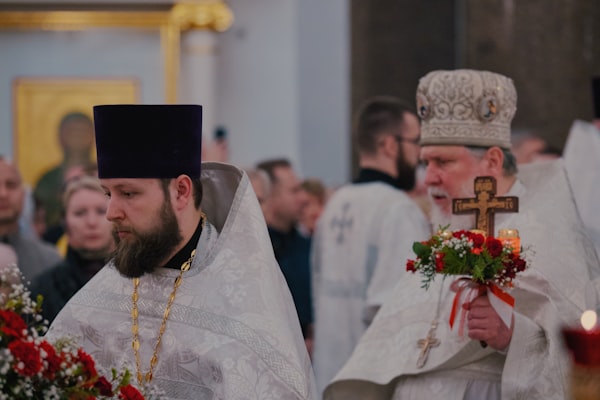 Two priests are in a religious procession.