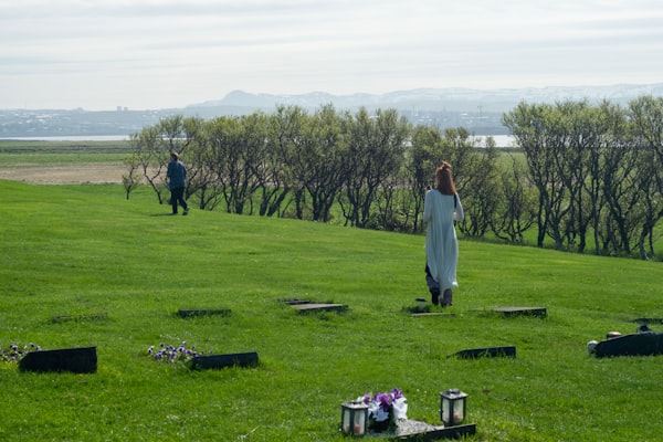 a woman in a white dress standing in a field