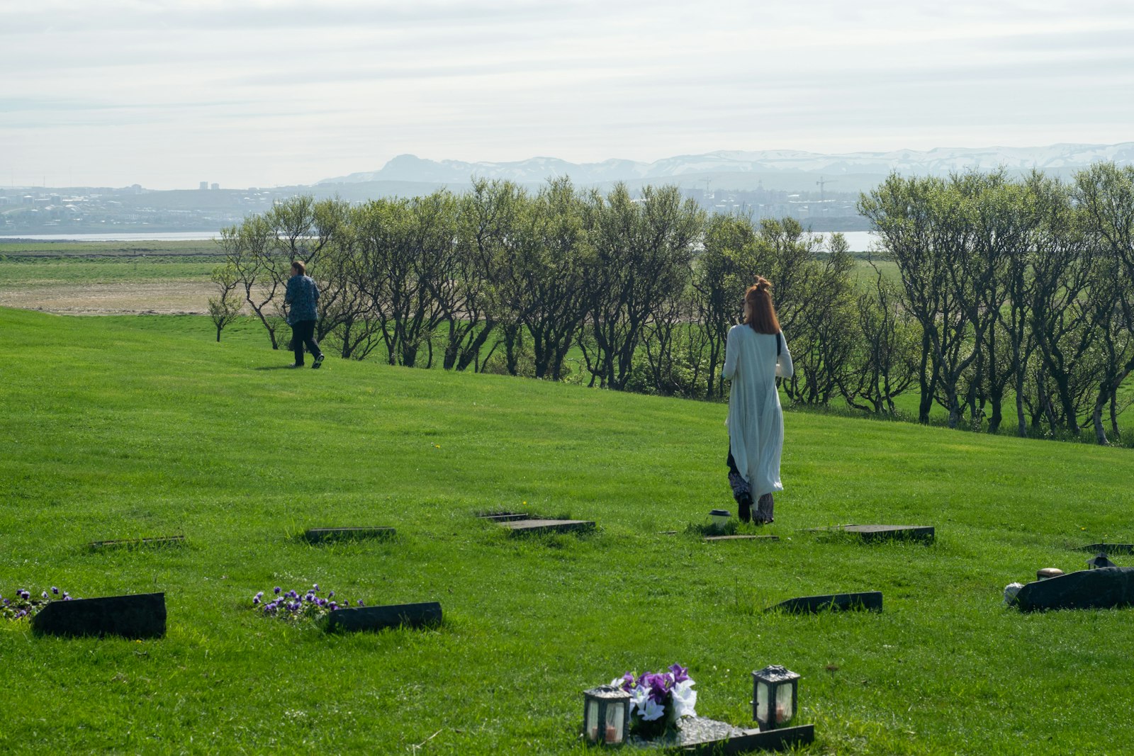 a woman in a white dress standing in a field