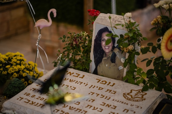 a memorial with flowers and a picture of a woman