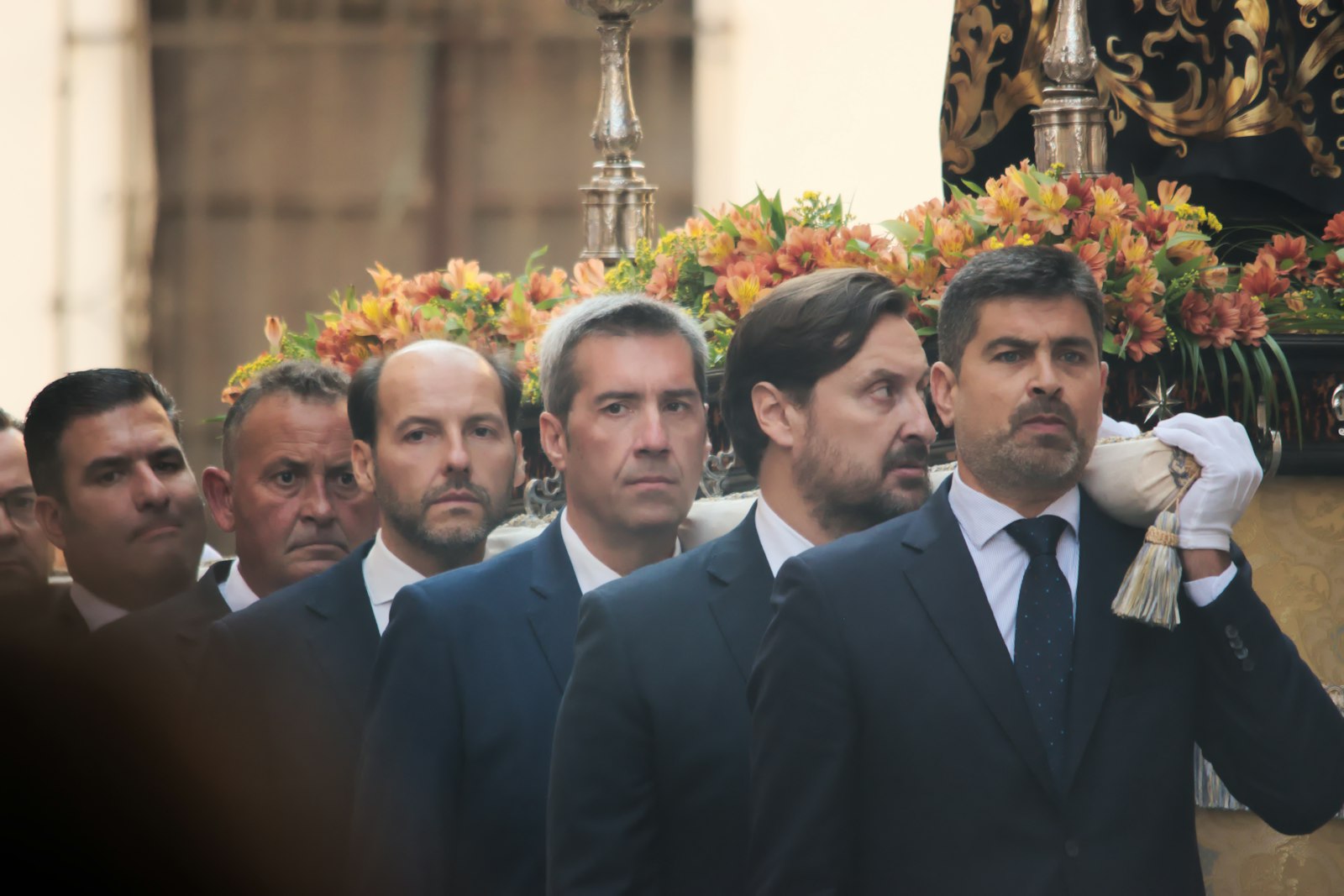 a group of men in suits and ties standing next to each other