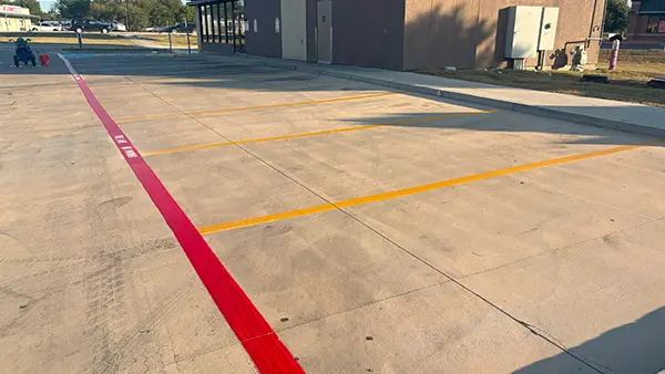 Yellow parking stall lines and a red fire lane.
