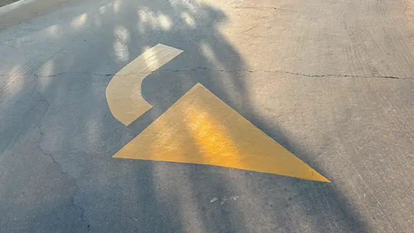 A curved yellow directional arrow.