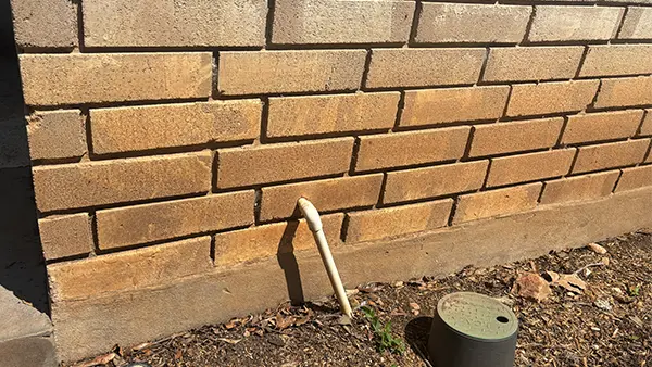 Red clay stains on brick siding.