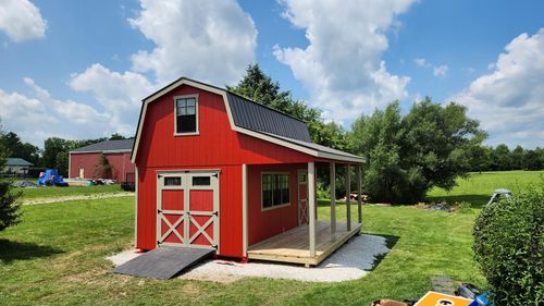red shed with porch and double barn doors