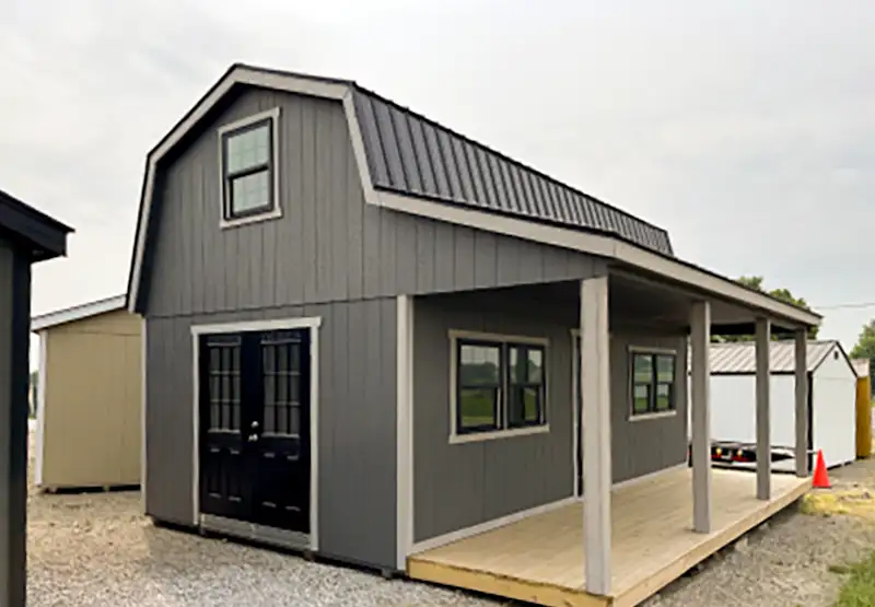 gray cabin with porch and side door