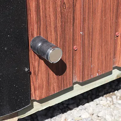magnetic door stop on the side of a shed