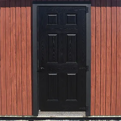 single 36" black fiberglass door on the side of a shed
