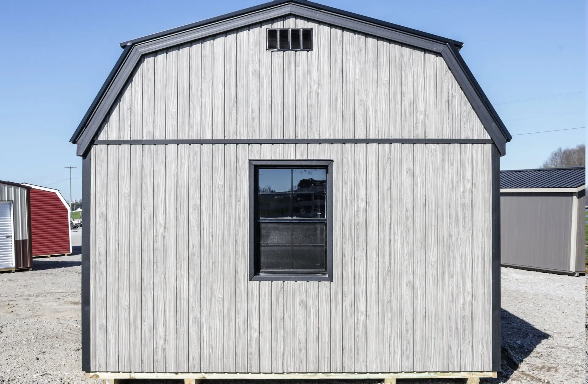 Back view of The Columbus shed model, with a single window in the middle and a gambrel roof style