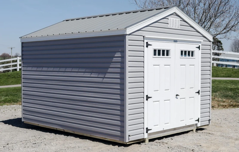 the lexington shed model with grey sideing, roof, and white double doors