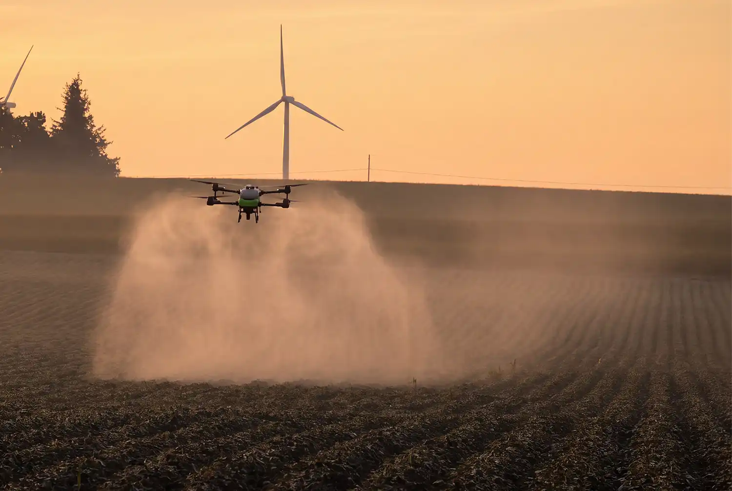 Revolution I-19 spray drone spraying soybean field at sunrise