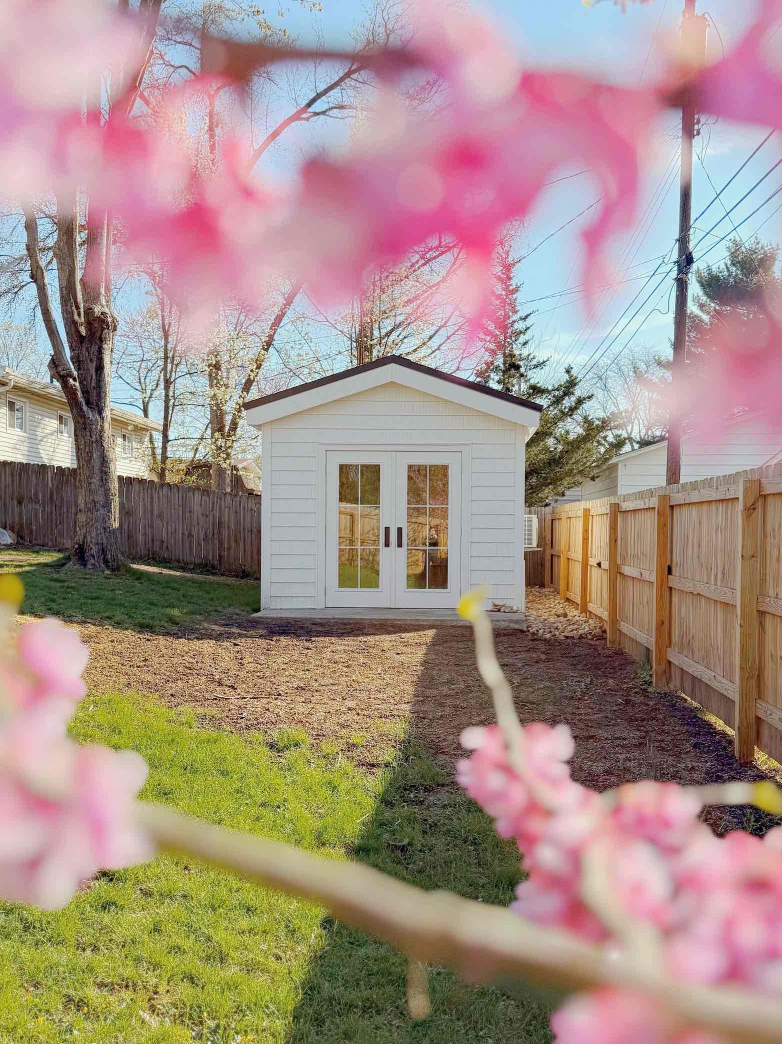 Pink flowers framing a backyard SIPs build in Worthington, Ohio.