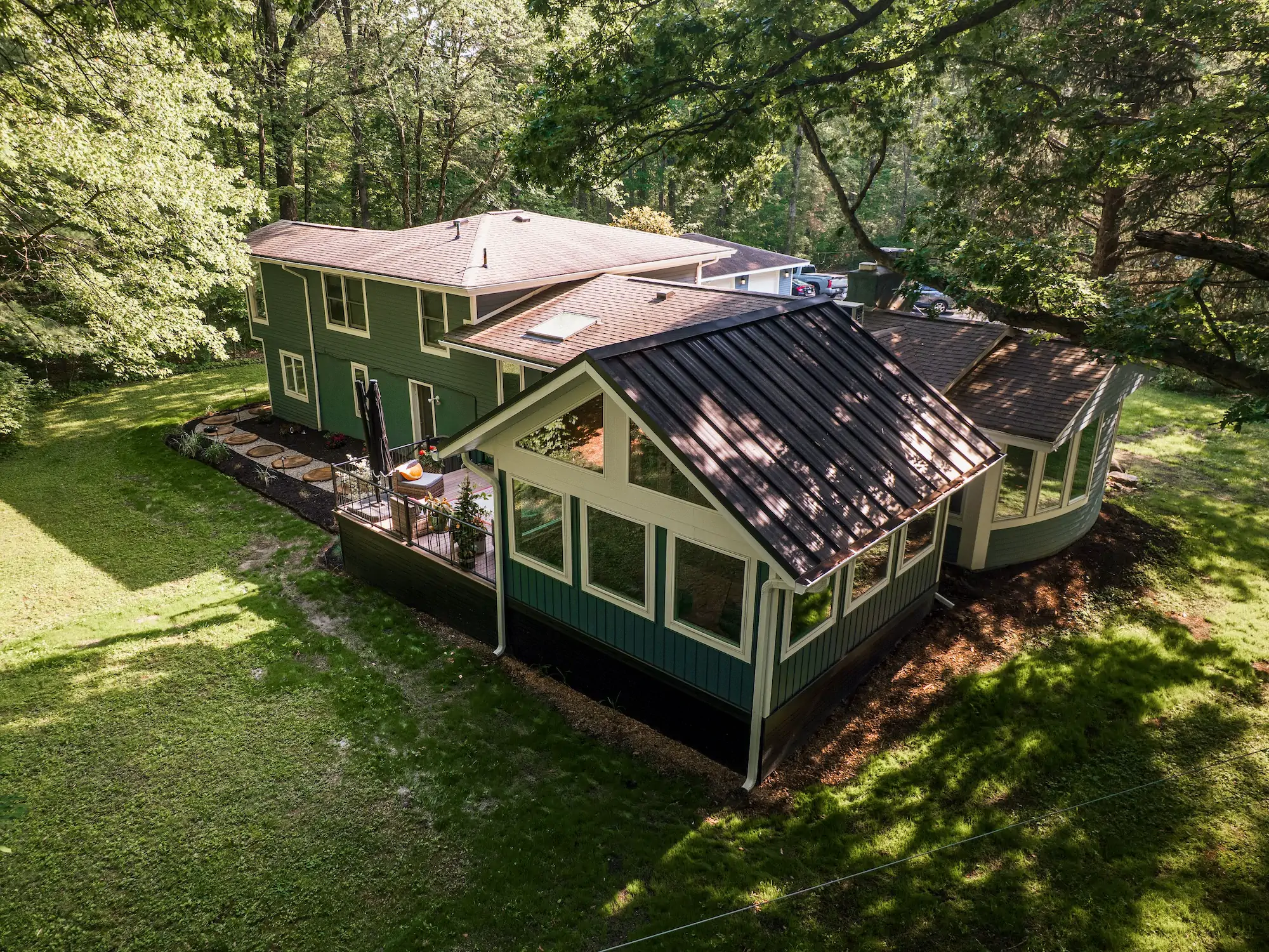 The inside of a sunroom with enormous windows.