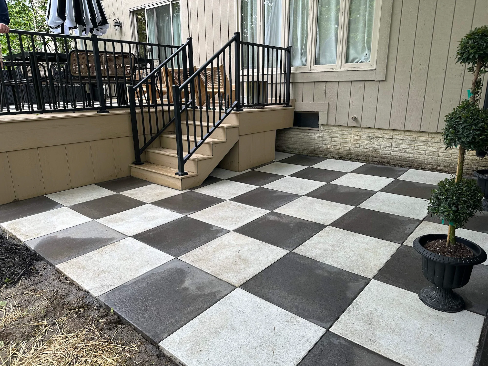 A custom-made Columbus paver patio with black and white "chess" tiles.