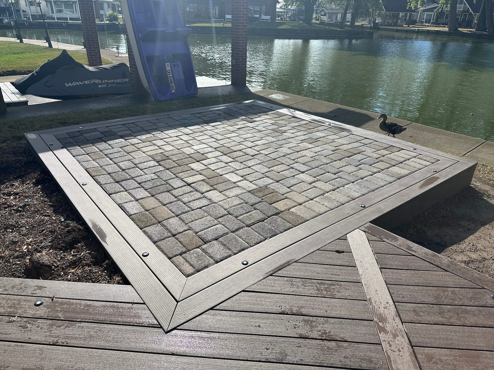 A WaveRunner and custom patio on a lakeside property.