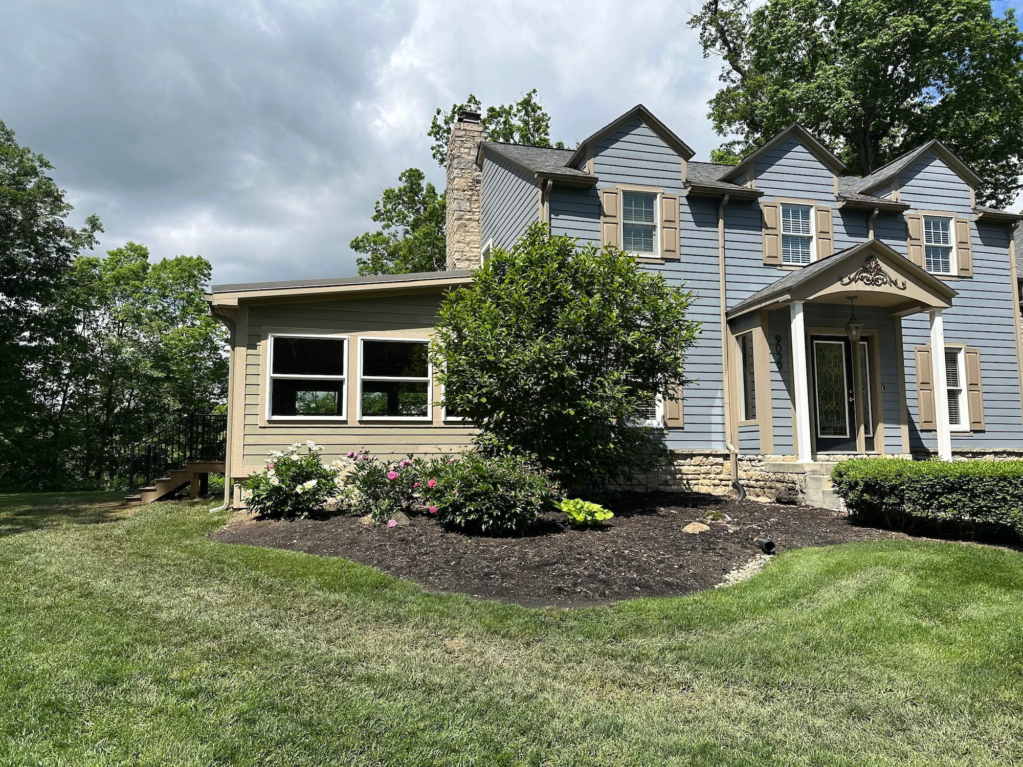 The exterior of a three season room lit up at night.