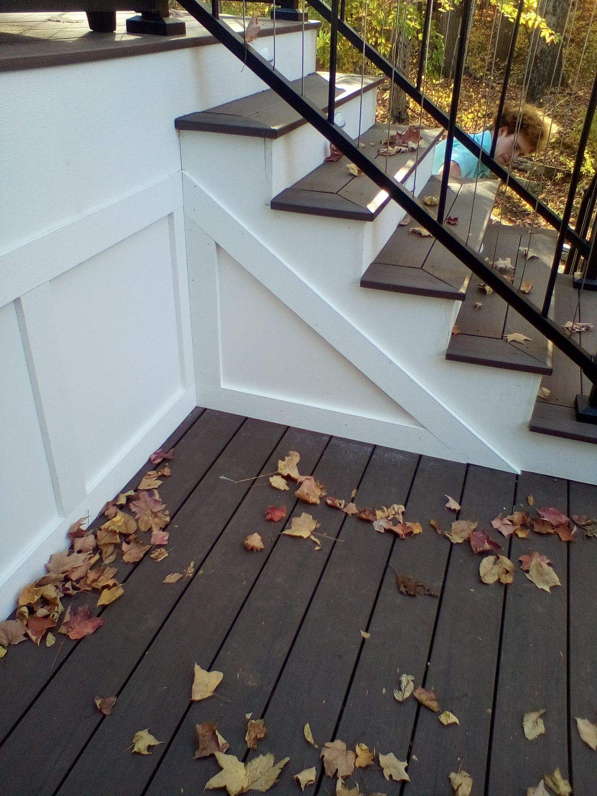 Side view of new steps and PVC apron on a deck project