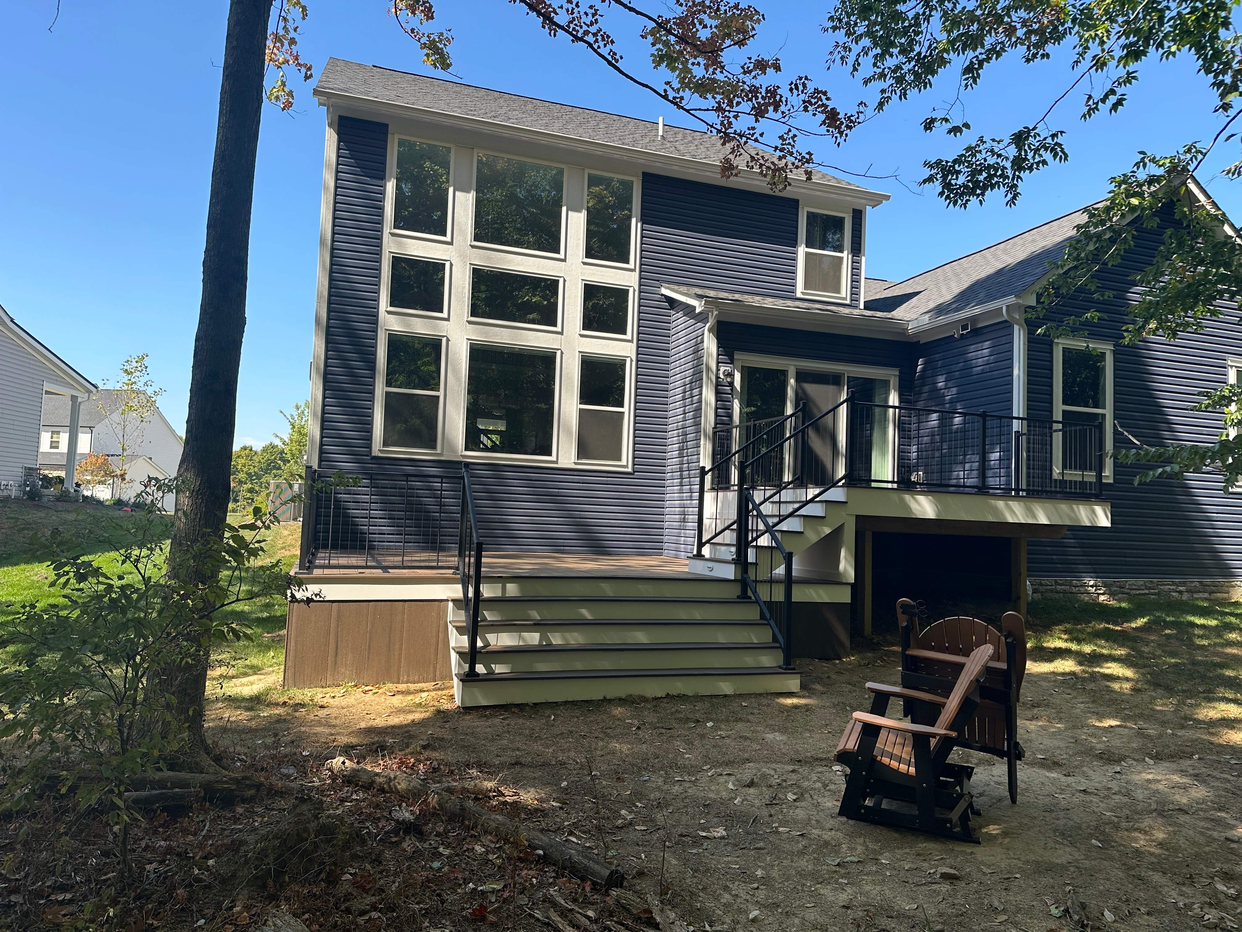 Full view of a home with a new multi-level deck addition.