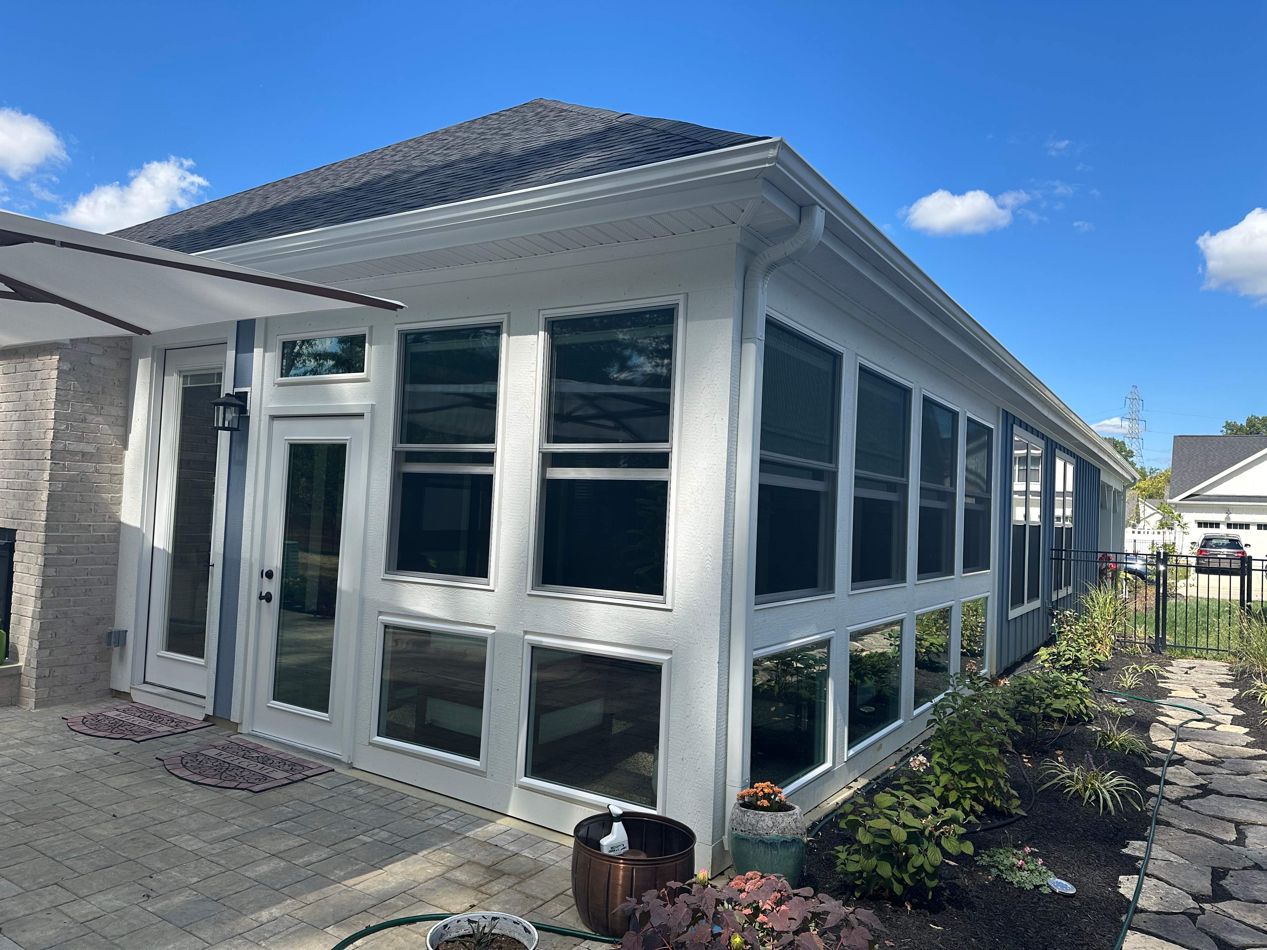 A beautiful sunroom with a glass knee wall system.