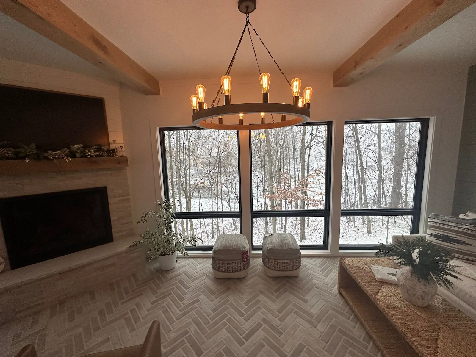 The interior of a four-season sunroom in Westerville, Ohio with a fireplace and chandelier.