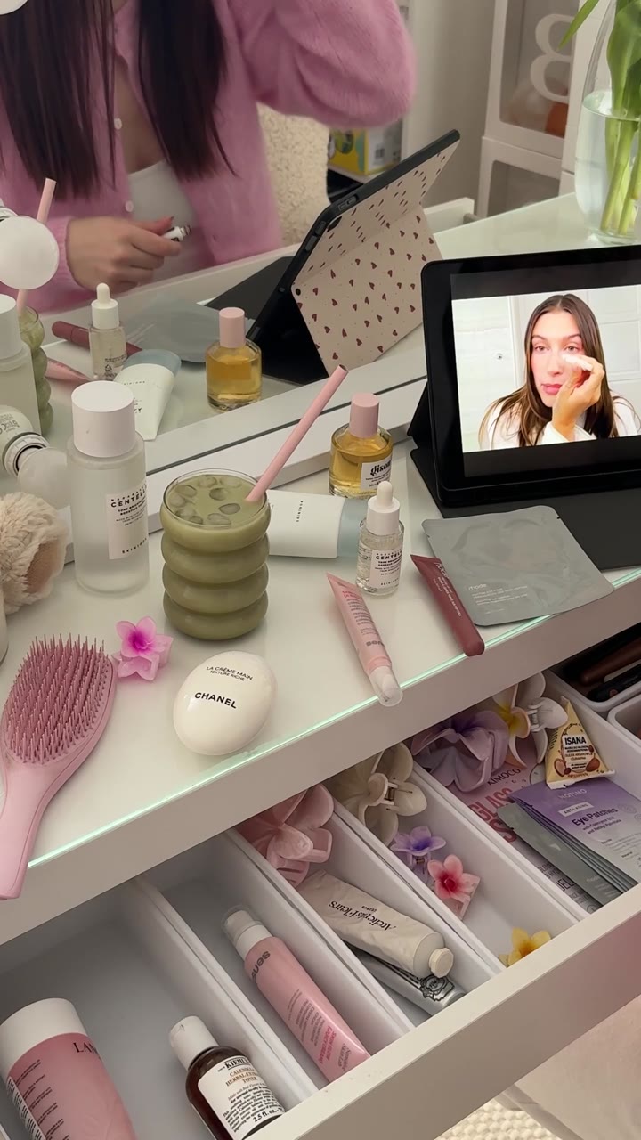 Pink vanity with skincare and a tablet