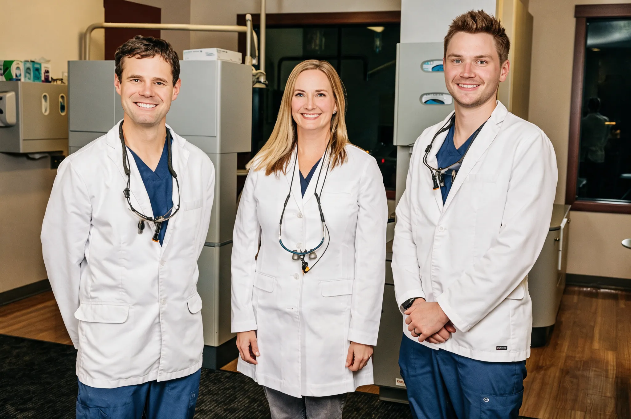 The three dentists at Clark Fork Dental in their Missoula, MT dental office, wearing white lab coats
