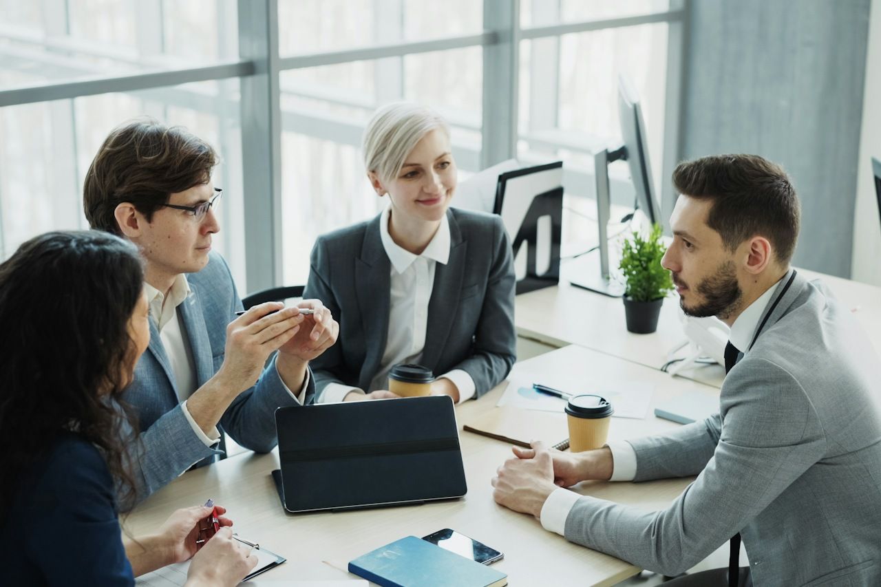 Manager and colleagues in a meeting at an office table