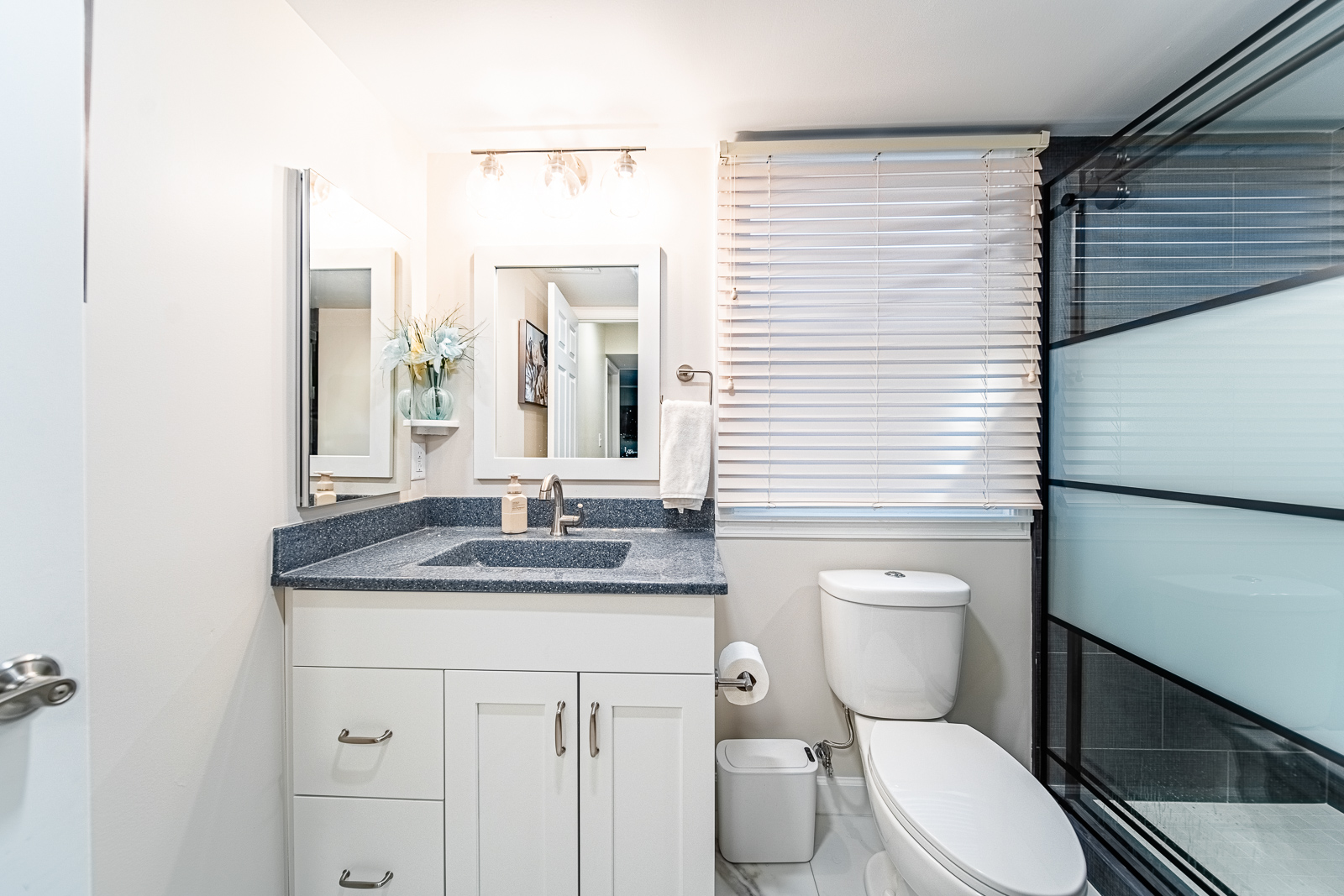 Large tiled walk-in shower with built-in niche, brushed nickel fixtures, and grab bars in Tippecanoe County bathroom remodel