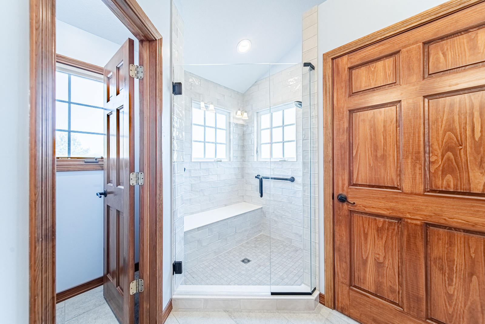 Full view of walk-in shower with glass door and tile walls in Lafayette bathroom remodel