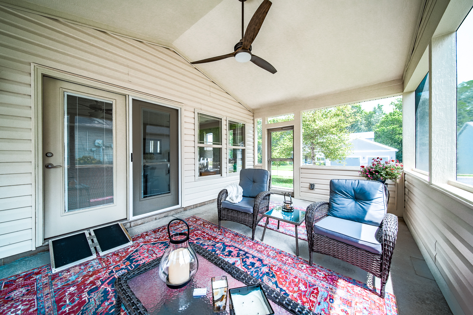 Wheelchair-accessible screened porch with storm door and landscaped exterior