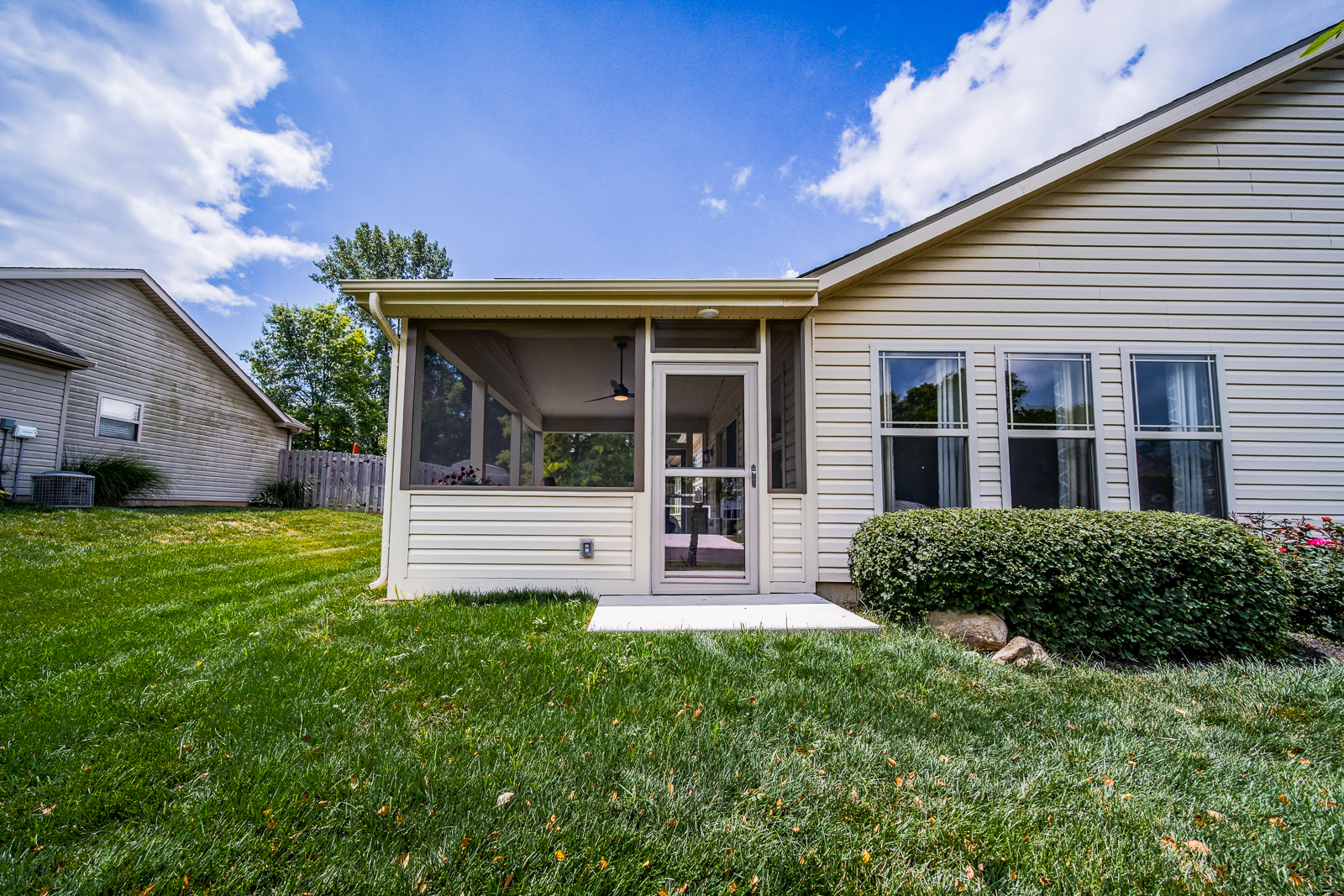 New porch room addition in West Lafayette with storm door exit and view to backyard