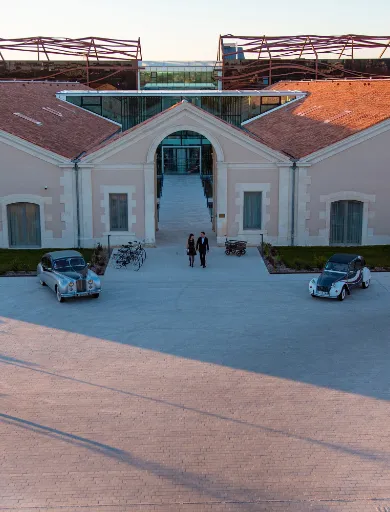 Hotel entrance with luxury car parked Hotel Chais Monnet & Spa Cognac